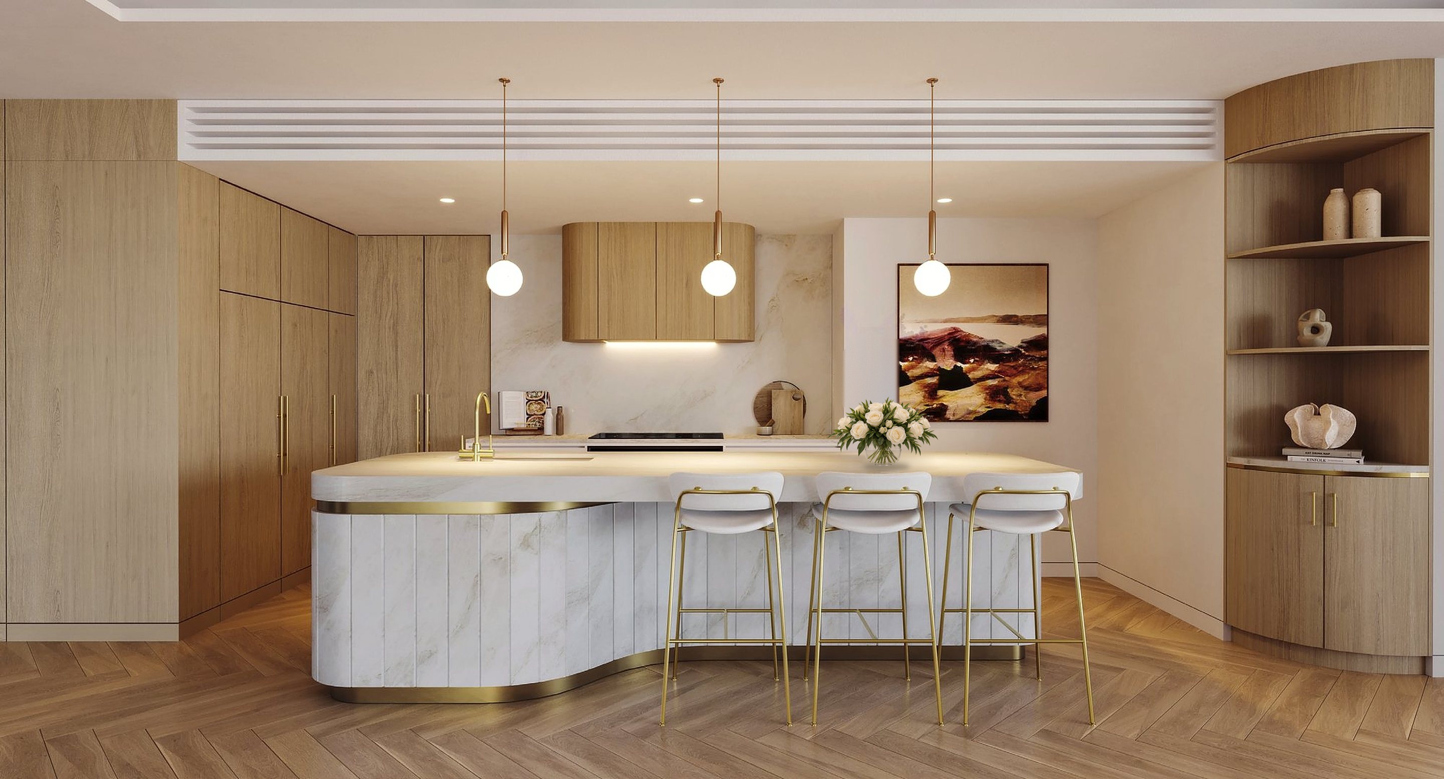 The same kitchen finished in warm custom timber joinery, with a sculptural stone island, brass stools and a glass bowl of white roses on the bench.